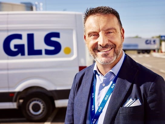 A GLS truck stands in front of a Wortmann company building